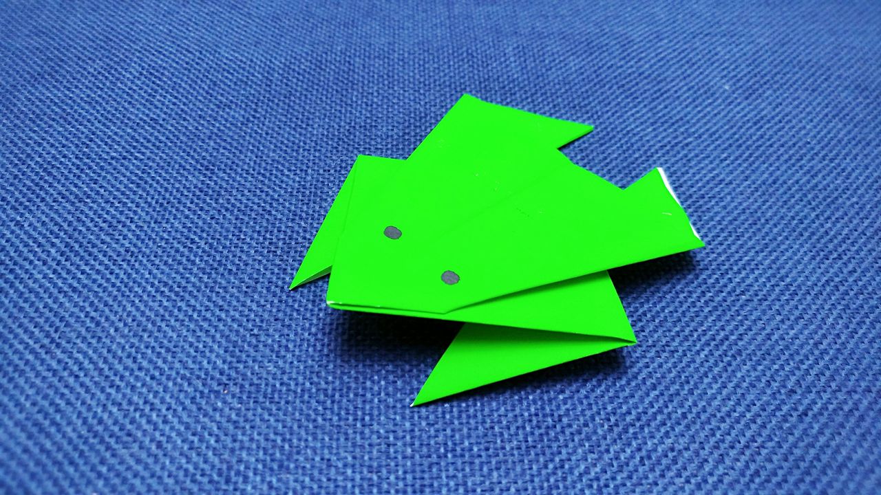 手工如何折纸青蛙 服务升级 3将正方形纸对折,做出角x折痕,翻面折三角