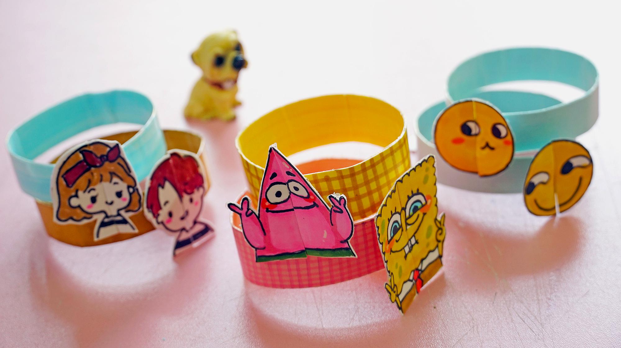 6卡通手环:卡纸对折画出图案,然后贴上透明胶并裁剪下来,裁剪合适长度